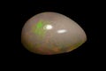 natural rainbow opal gem isolated on black background Royalty Free Stock Photo
