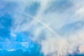 Natural rainbow over blue sky and white clouds Royalty Free Stock Photo