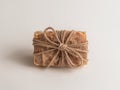 Natural Rectangular Object Wrapped with Twine, Displayed on a Plain White Surface. Royalty Free Stock Photo