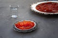 Natural red caviar on silver plate on gray table Royalty Free Stock Photo