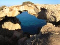 Natural rock arch surrounded by the sea in Cape Greco National Forest Park in Cyprus Royalty Free Stock Photo