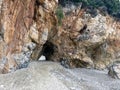 Natural rock archway at sandy beach with unique geological formations Royalty Free Stock Photo