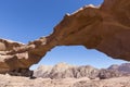 Natural rock bridge and panoramic view of Wadi Rum desert Royalty Free Stock Photo