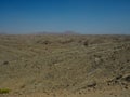 Natural rock desert valley panorama landscape view looking like Mars surface scene with mountain and blue sky background Royalty Free Stock Photo