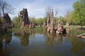 natural rock formations towering over a tranquil pond