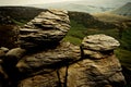 A natural rocks formation with a view of the green fields of the Royalty Free Stock Photo