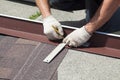 Natural roof tile instaalation. Roofer builder worker marks the distance between the seams. Royalty Free Stock Photo