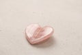 Natural rose quartz heart stone on light background. Natural stones, crystals for magic, lithotherapy, geology, minerals, stone