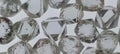 Natural rough crystal diamonds on white assorting pad in Antwerp Belgium. Royalty Free Stock Photo