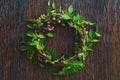 Natural Round Wreath Frame on Wooden Background. Greeting Card