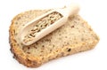 Natural rye grain on wooden spoon and slice of bread Royalty Free Stock Photo