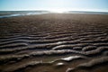 Natural sand patterns in beach at low tide.