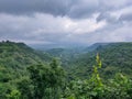 Dark Rain Clouds and Beautiful Green Valley Royalty Free Stock Photo