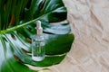 Natural Serums. Cosmetic hydrating serum in a glass bottle with pipette close up. Hyaluronic acid on abstract background