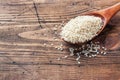 Natural sesame seeds in a wooden spoon. Wooden table. copy space