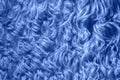 Natural sheepskin painted blue. Curly decorative fur texture. Wool background Royalty Free Stock Photo