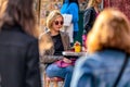 Natural shot of a beautiful blonde lady with short hair and sunglasses sitting in a cafe