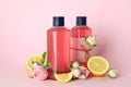 Natural shower gels and ingredients on pink background