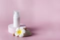 Natural skincare product branding mock up Blank white squeeze bottle plastic tube on circle podium with flower Packaging of cream Royalty Free Stock Photo