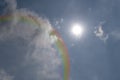 Natural sky cloudscape rainbow with blue sky and white clouds and colorful rainbow in the sky. A bright rainbow in the sky Royalty Free Stock Photo