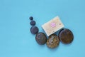 Natural soap bar and round stone on blue background Royalty Free Stock Photo