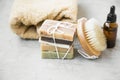 Natural soap, handmade organic natural soap with body brush, oil bottle and cotton towel, spa and wellness products still life Royalty Free Stock Photo