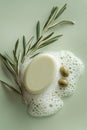 Natural soap with olive oil and fresh herbs placed on a frothy surface in a minimalistic setting Royalty Free Stock Photo