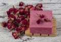 Natural soap, Rose Soap. Natural handmade soap with dried pink roses on wooden board. Spa Royalty Free Stock Photo