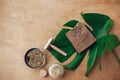 Natural soap, solid shampoo in metal tin, reusable razor, ubtan on wooden background with green monstera leaf. Plastic free beauty Royalty Free Stock Photo