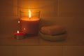 Natural soap, wax candle lights burning flame in shower bathtub. Spa care beauty Royalty Free Stock Photo