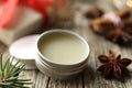 Natural solid perfume in container and anise star on wooden table, closeup Royalty Free Stock Photo