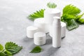 Natural spa, herbal cosmetics. Nettle lotion, shampoo and cream in a bottle and nettles leaves. Medicinal herb for health and
