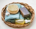 Natural spa skincare and beauty products. Rosemary herb, oil bottle, body brush and towel