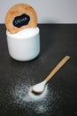 Natural stevia sweetener in a white bowl with a wooden spoon, grey marble table Royalty Free Stock Photo