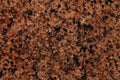 Natural stone granite background. Bright hard rock texture. Red granite stone. Granite untreated surface Royalty Free Stock Photo