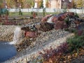 Natural stone landscaping in city park. Beautiful landscaped garden with rocks and waterfall. Nice landscape design in autumn Royalty Free Stock Photo