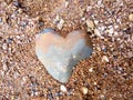 Natural stone in the shape of a heart on the river beach Royalty Free Stock Photo