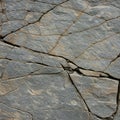 Natural stone wall with irregular slate slabs, arranged in an interlocking pattern. The Royalty Free Stock Photo