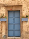 natural stone wall  traditional construction techniques  garden gate made of ferrous metal and painted blue Royalty Free Stock Photo