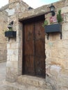 natural stone wall  traditional construction techniques  garden gate made of wood Royalty Free Stock Photo