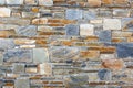 Natural stone wall with yellow and blue tones Royalty Free Stock Photo