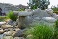 Natural stone waterfall cascade in pond design.