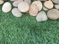 Natural stones and artificial green grass Royalty Free Stock Photo