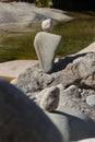 Natural stones layered to a figure on a mountain lake