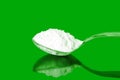 Natural sugar powder in spoon in green background Royalty Free Stock Photo