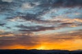 Natural Sunset Sunrise Over Field Or Meadow. Bright Dramatic Sky And Dark Ground. Countryside Landscape Under Scenic Colorful Sky Royalty Free Stock Photo