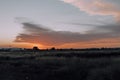 Natural Sunset Sunrise Over Field Or Meadow. Bright Dramatic Sky And Dark Ground. Countryside Landscape Under Scenic Colorful Sky Royalty Free Stock Photo