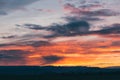 Natural Sunset Sunrise Over Field Or Meadow. Bright Dramatic Sky And Dark Ground. Countryside Landscape Under Scenic Colorful Sky Royalty Free Stock Photo