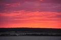 Natural Sunset Sunrise Over Field Or Meadow. Pink Color Sky Over Winter Snowy Ground. Landscape Under Scenic Sky At Royalty Free Stock Photo