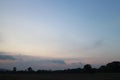 Natural Sunset Sunrise Over Field Or Meadow. Real amazing panoramic sunrise or sunset sky with gentle colorful clouds. Royalty Free Stock Photo